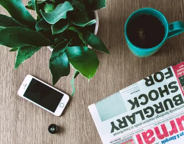 Phone and Newspaper on desk