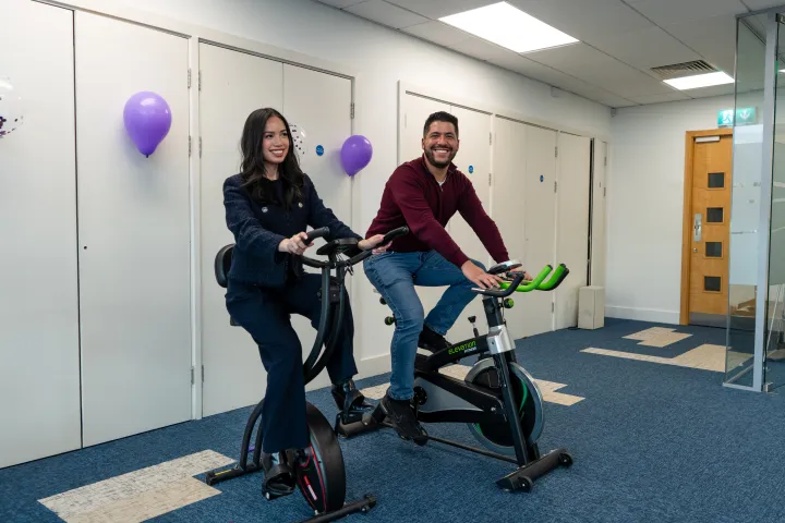 Two employees from IP Telecom, on a exercise bike 