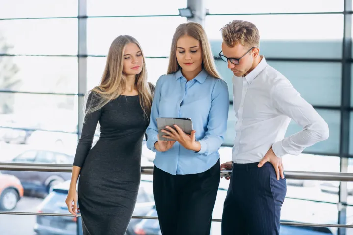 three sales colleagues with a tablet pc