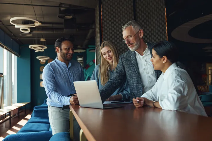Team smiling at laptop