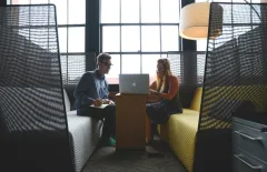 Man and woman working on laptop