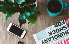 Phone and Newspaper on desk