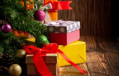 Presents wrapped beside a Christmas tree