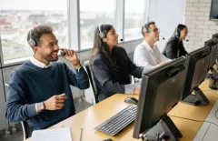 support team on calls with computers 