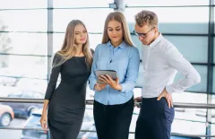 three sales colleagues with a tablet pc